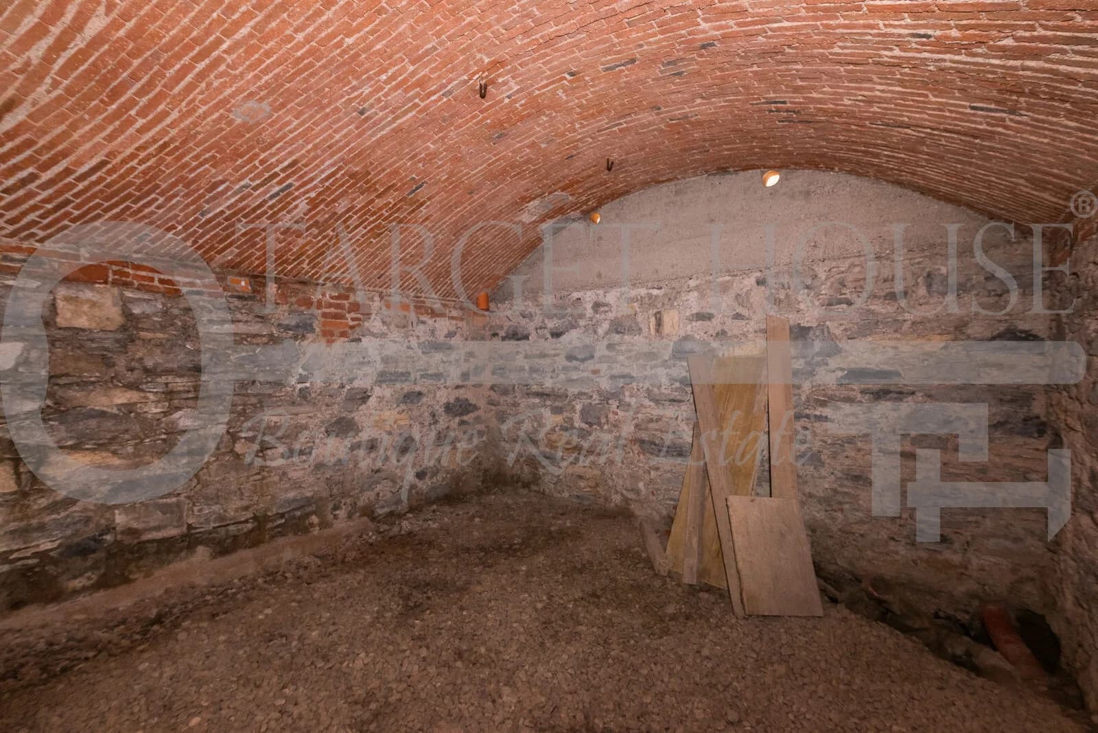 Vaulted brick cellar with stone walls and earthen floor in historic villa near Como