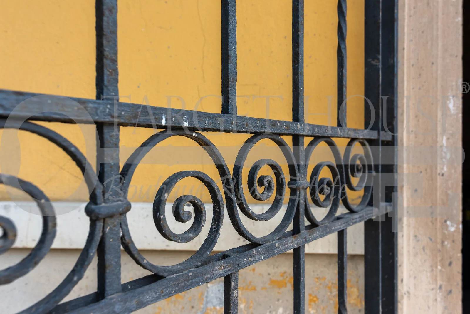 Ornate wrought iron gate with spiral scrollwork detail at historic villa near Como